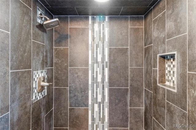 bathroom with a tile shower