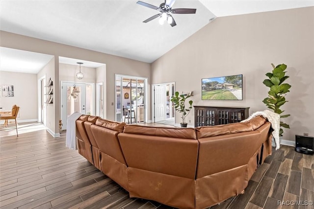 living room featuring dark hardwood / wood-style floors, ceiling fan, high vaulted ceiling, and french doors