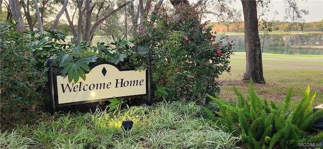 community / neighborhood sign with a water view