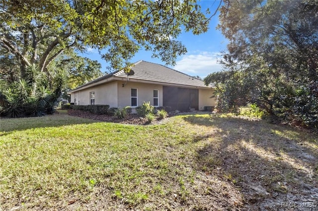 view of side of home featuring a yard