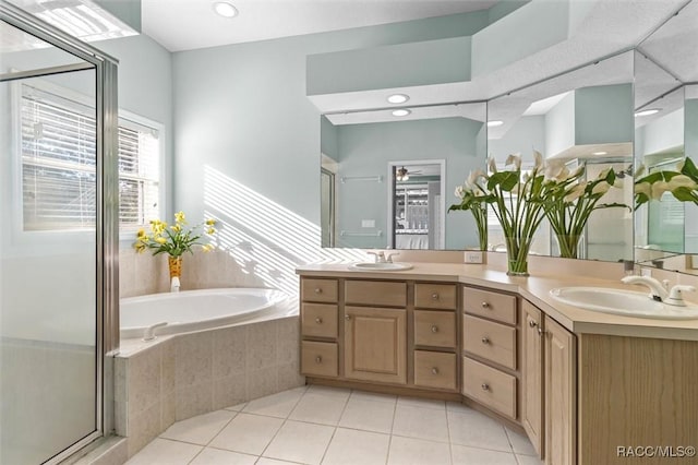 bathroom with tile patterned floors, vanity, and plus walk in shower