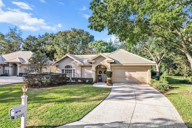 single story home featuring a garage and a front lawn