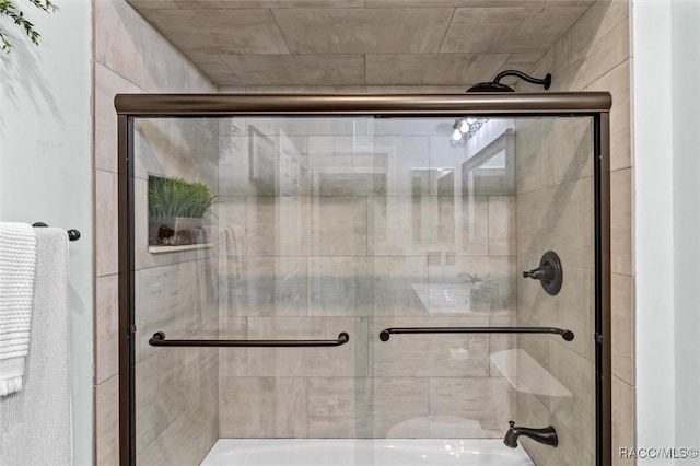 bathroom with a shower with door