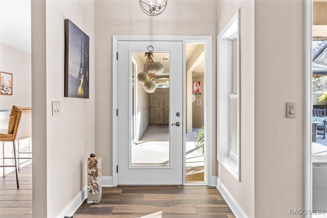 doorway with dark wood-type flooring