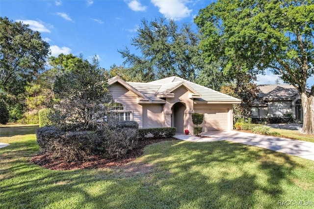 ranch-style house featuring a garage and a front yard