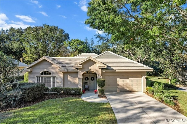 single story home with a front yard and a garage