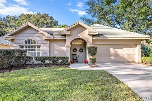 ranch-style home with a front lawn and a garage