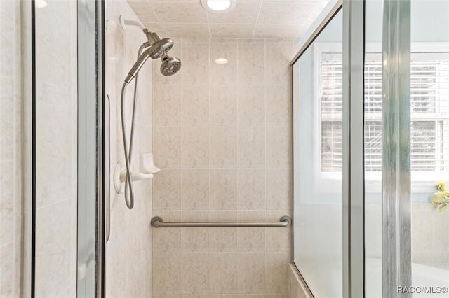 bathroom featuring a shower with shower door