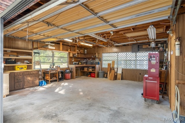 garage featuring a workshop area and wood walls