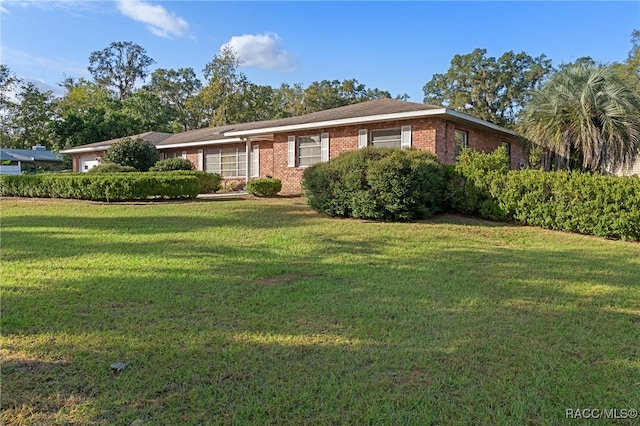 ranch-style home featuring a front yard