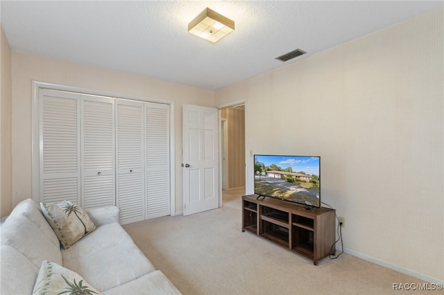 carpeted living room with a textured ceiling