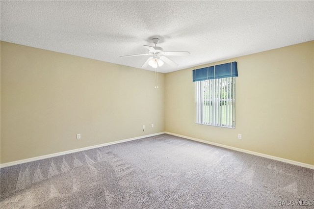 carpeted empty room with ceiling fan and a textured ceiling