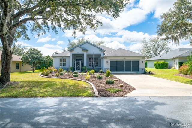 view of front of property with a garage, concrete driveway, a front lawn, and stucco siding