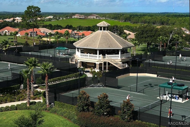 view of tennis court with a gazebo and fence