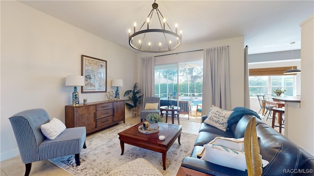 living room with plenty of natural light, tile patterned flooring, and an inviting chandelier