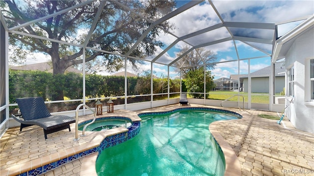 view of pool with a pool with connected hot tub, a patio area, and a lanai