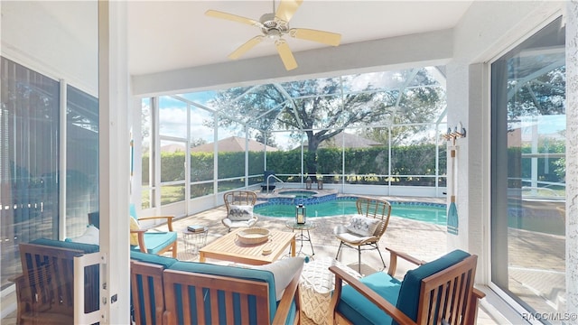 sunroom / solarium featuring a ceiling fan and a swimming pool