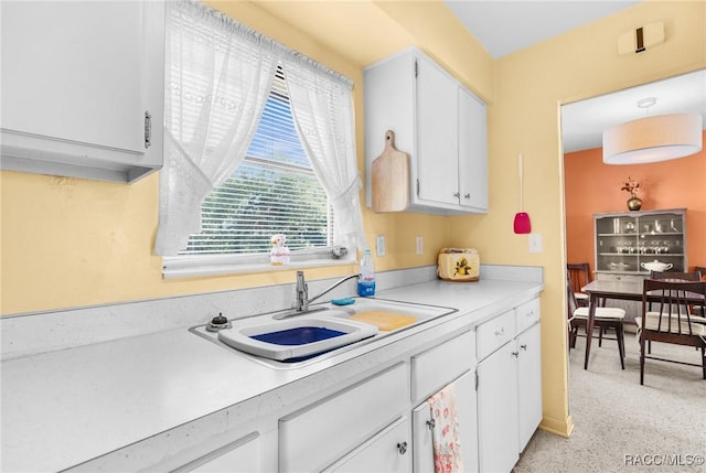 kitchen with white cabinetry and sink