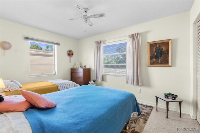 bedroom with ceiling fan and a closet