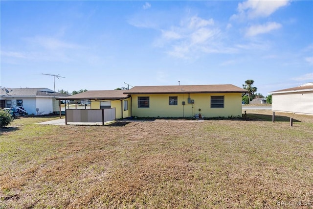 back of house featuring a yard