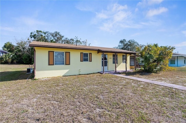 ranch-style house featuring central AC unit and a front lawn