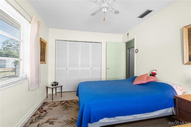 bedroom featuring ceiling fan and a closet