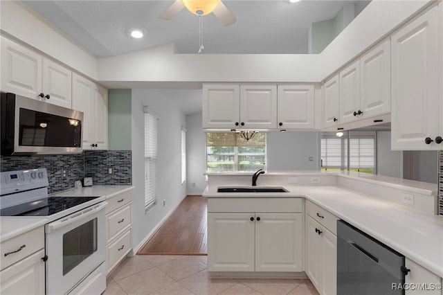 4614 N Webster Island Ter, Hernando, FL 34442 - kitchen with stainless steel microwave, white electric range oven, dishwasher, plenty of natural light, and recessed lighting