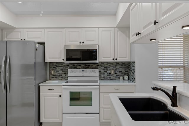 4614 N Webster Island Ter, Hernando, FL 34442 - kitchen with appliances with stainless steel finishes, light countertops, decorative backsplash, and white cabinetry