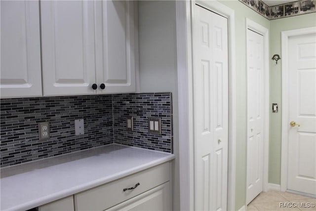 4614 N Webster Island Ter, Hernando, FL 34442 - kitchen with tasteful backsplash, light countertops, light tile patterned floors, and white cabinetry