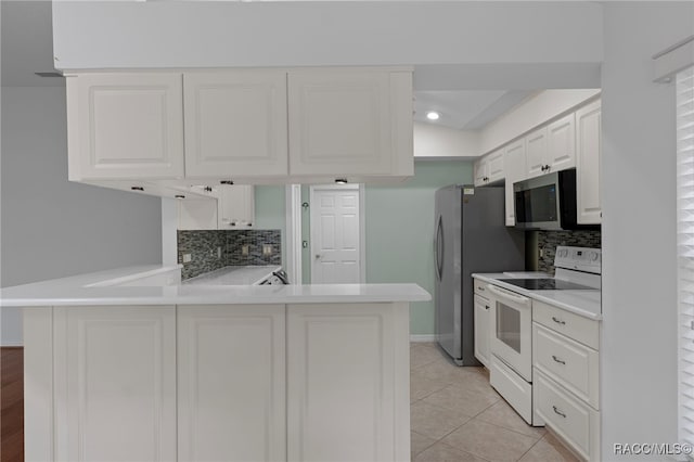 4614 N Webster Island Ter, Hernando, FL 34442 - kitchen with appliances with stainless steel finishes, backsplash, light countertops, and a peninsula