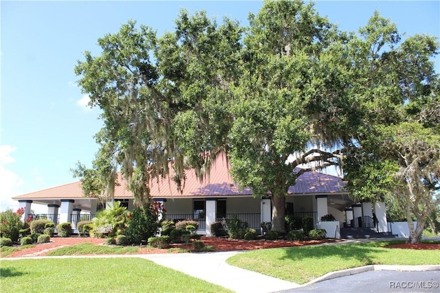4614 N Webster Island Ter, Hernando, FL 34442 - view of front of property featuring a front yard, covered porch, a metal roof, and stucco siding