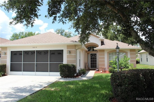 4614 N Webster Island Ter, Hernando, FL 34442 - ranch-style house with concrete driveway, a garage, stucco siding, a front yard, and roof with shingles