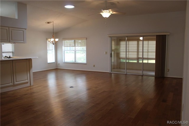 4614 N Webster Island Ter, Hernando, FL 34442 - unfurnished living room with a ceiling fan, a chandelier, vaulted ceiling, and dark wood-style flooring