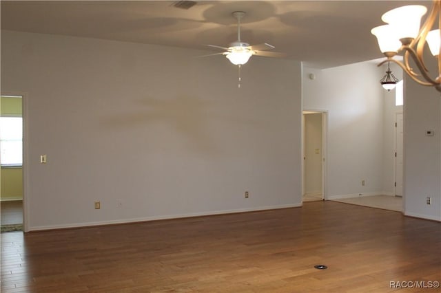 4614 N Webster Island Ter, Hernando, FL 34442 - empty room with wood finished floors, ceiling fan, and a chandelier