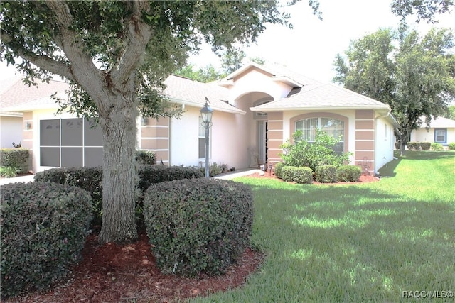 4614 N Webster Island Ter, Hernando, FL 34442 - ranch-style home with stucco siding, a front lawn, and a shingled roof