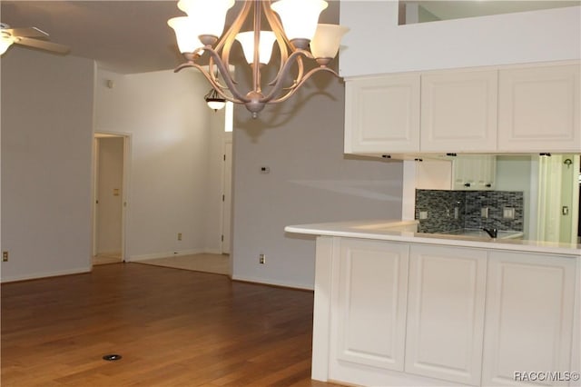 4614 N Webster Island Ter, Hernando, FL 34442 - kitchen with a chandelier, decorative backsplash, light wood-type flooring, white cabinets, and light countertops