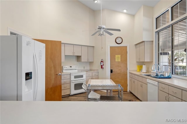4614 N Webster Island Ter, Hernando, FL 34442 - kitchen with white appliances, a high ceiling, dark wood finished floors, ceiling fan, and light countertops