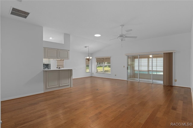4614 N Webster Island Ter, Hernando, FL 34442 - unfurnished living room featuring a chandelier, a ceiling fan, wood finished floors, and lofted ceiling