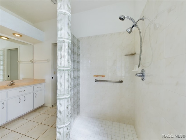 bathroom featuring tile patterned floors, vanity, and tiled shower