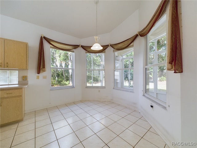 unfurnished dining area featuring light tile patterned floors