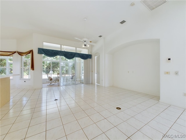 tiled empty room featuring ceiling fan