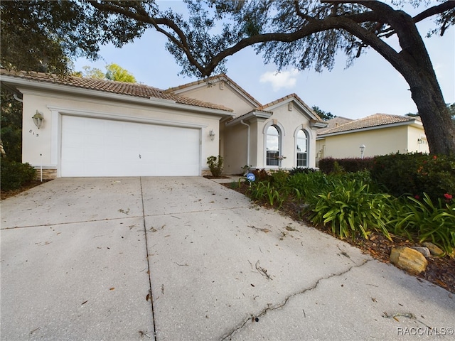 mediterranean / spanish-style home with a garage