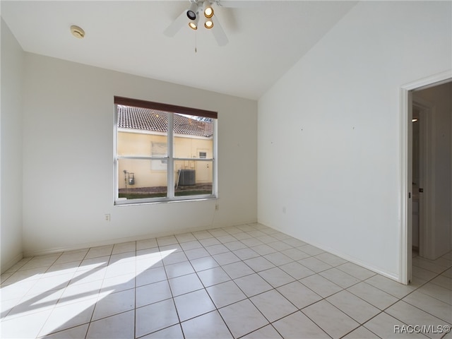 tiled spare room featuring ceiling fan and vaulted ceiling