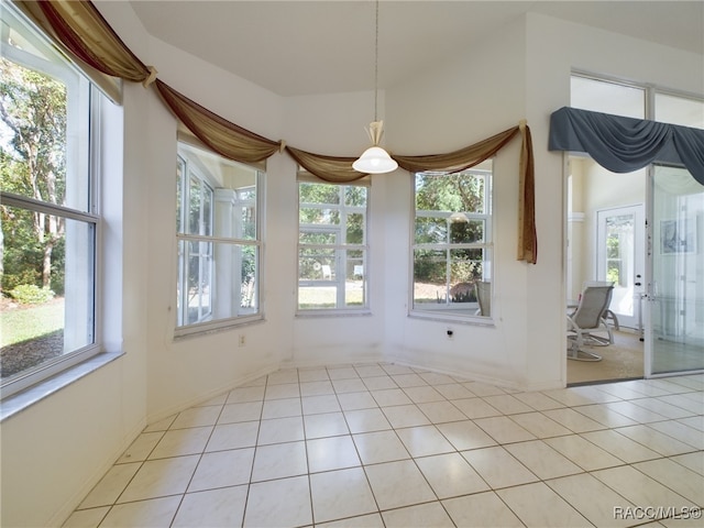 unfurnished dining area featuring light tile patterned floors and a healthy amount of sunlight