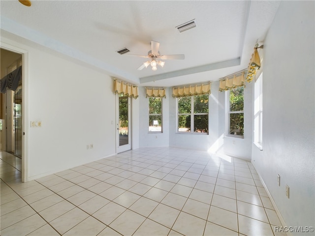 spare room with ceiling fan and light tile patterned floors