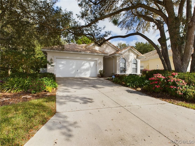 mediterranean / spanish-style home with a garage