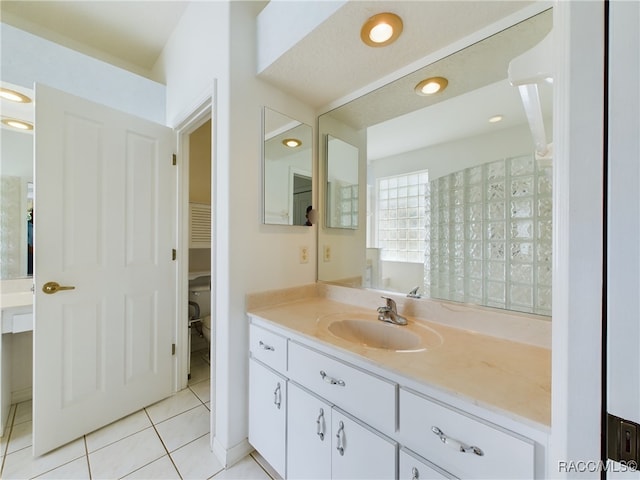 bathroom featuring tile patterned floors, vanity, and toilet