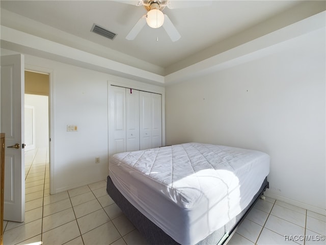 tiled bedroom with a closet and ceiling fan