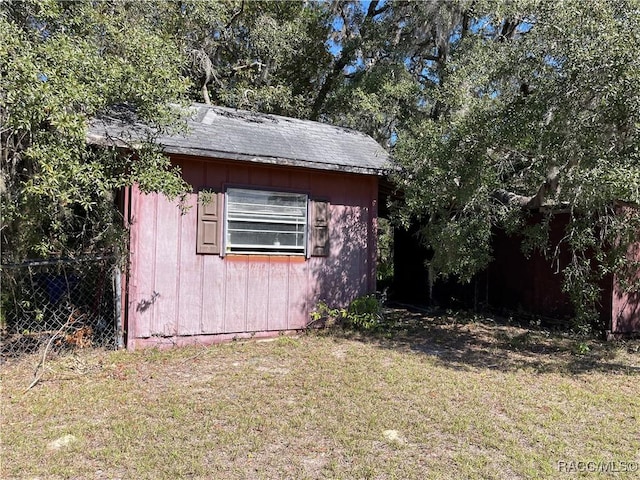 view of outbuilding with an outbuilding and fence