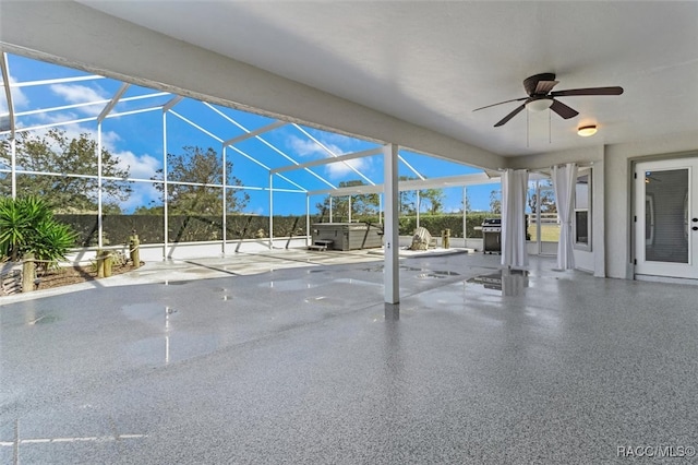 view of patio / terrace with glass enclosure, ceiling fan, a hot tub, and grilling area